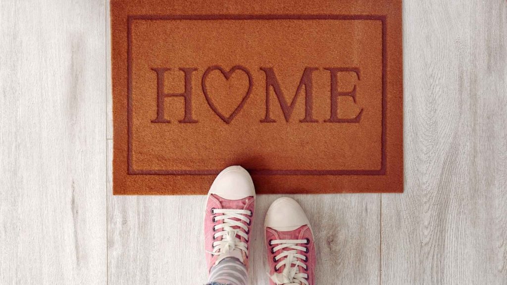 PHP vs. Inpatient Treatment: What Makes Partial Hospitalization Different? 2 Person standing at home, representing recovery options that allow returning home after treatment sessions