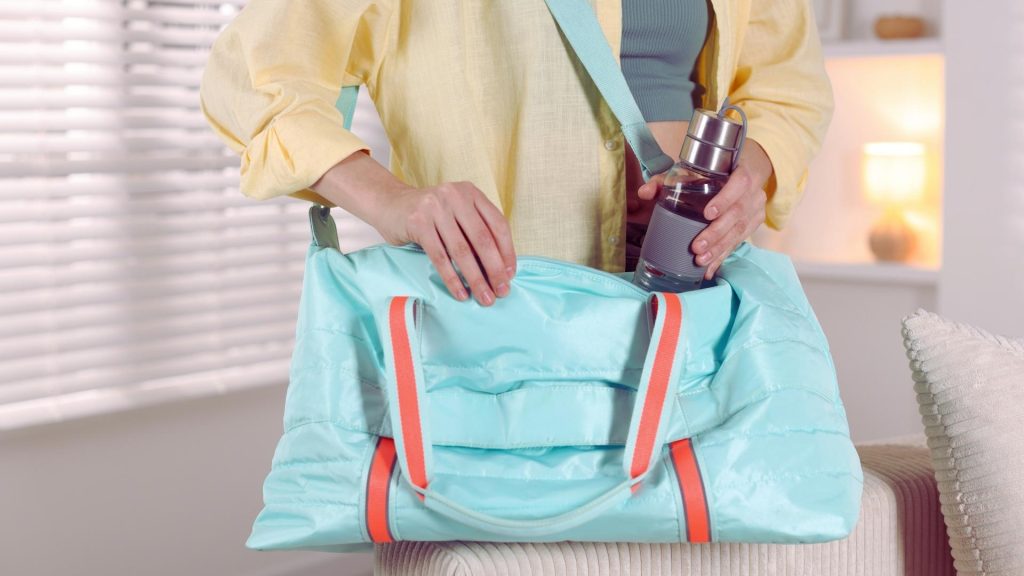 Person packing a bag with essentials while preparing for intensive outpatient treatment.