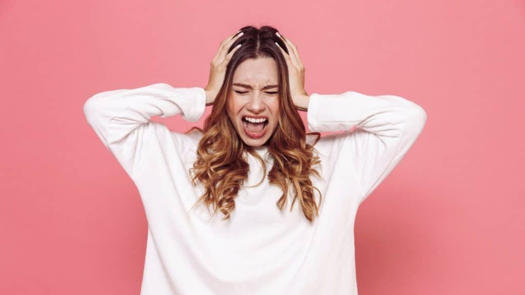 Person showing frustration and emotional overwhelm associated with irritability on Adderall.