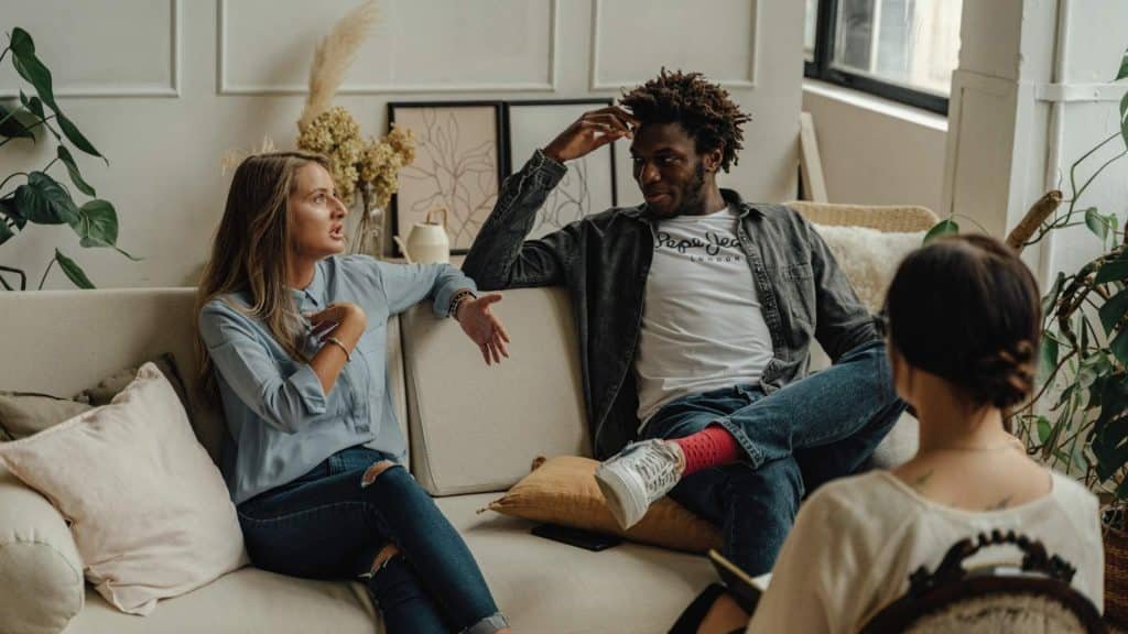 People in a family therapy session discussing alcohol recovery options