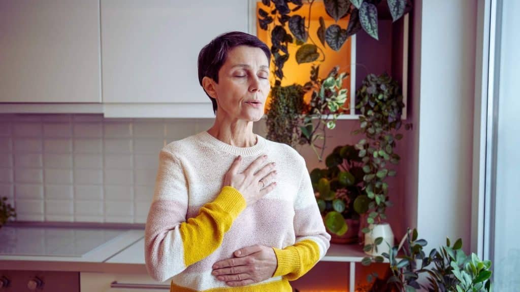 Person using deep breathing to manage alcohol cravings