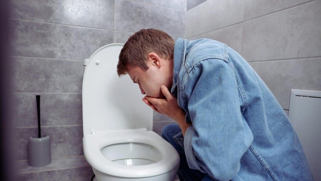 Person experiencing nausea and vomiting associated with CHS symptoms