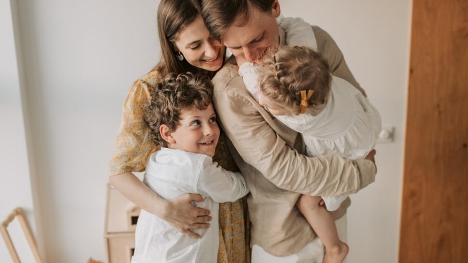 Is Alcoholism Hereditary a family embraces each other while thinking about hereditability of alcoholism.